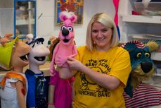 Alexandra Ashworth poses with pink puppet on her arm